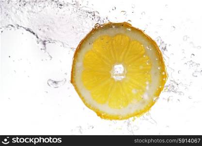 slice of lemon in water with bubbles