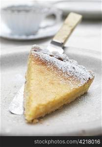 Slice of lemon tart on plate