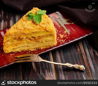 Slice of Napoleon Cake on a red ceramic plate