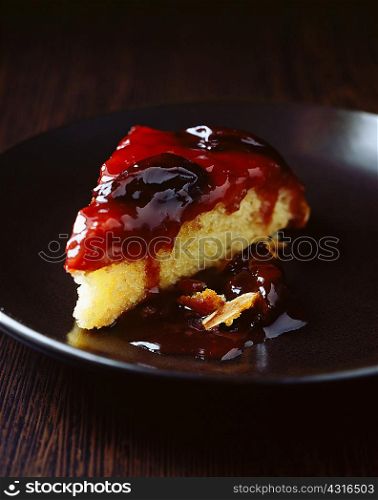 Slice of plum sponge cake on plate