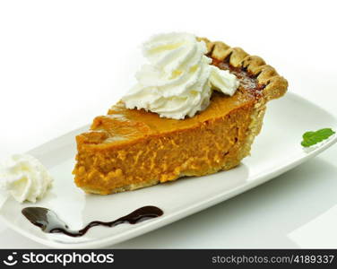 Slice of pumpkin pie with whipped cream on top
