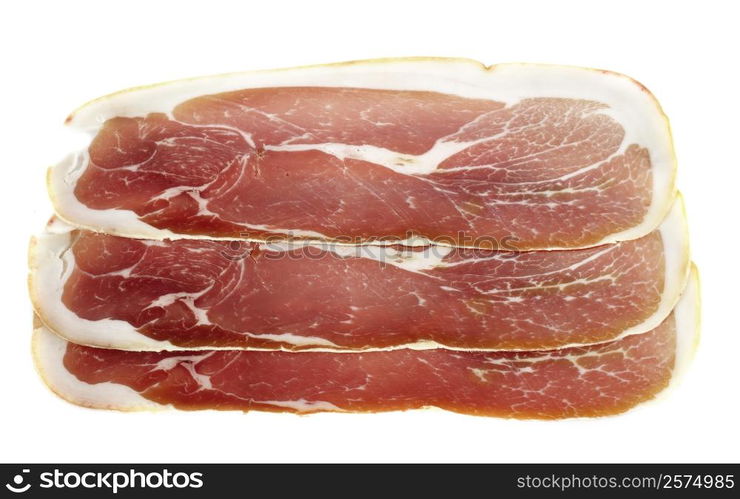 slice of raw ham in front of white background