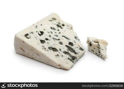 Slice of Roquefort cheese on white background