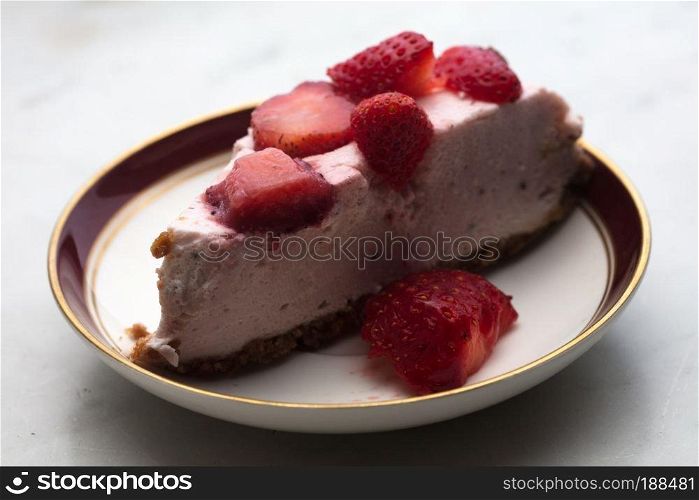 slice of strawberry cheesecake on white background, selective focus,