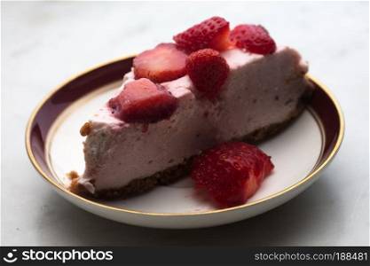 slice of strawberry cheesecake on white background, selective focus,