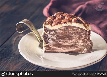 Slice of tiramisu crepe cake on the plate