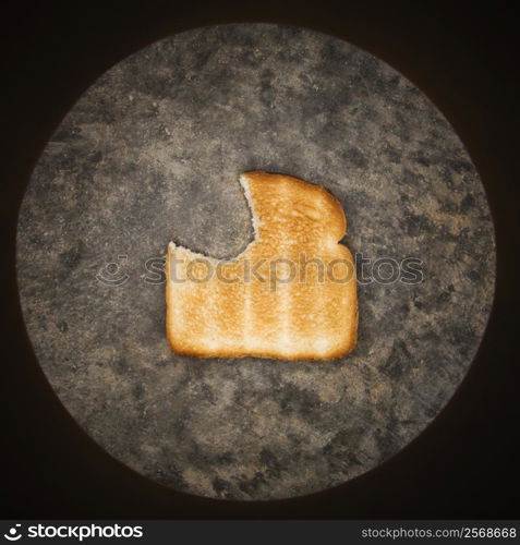 Slice of toast with bite missing.
