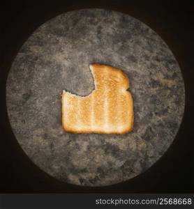 Slice of toast with bite missing.