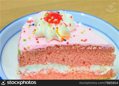 slice of Victoria sponge cake on plate background