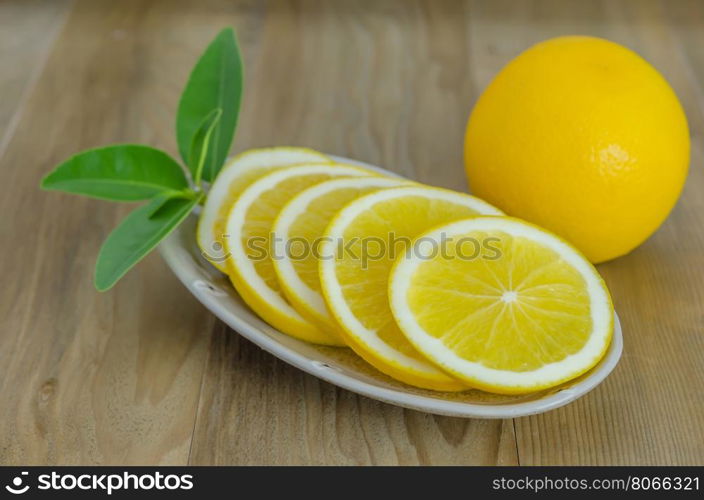 slice orange on dish . slice orange on dish over wooden background