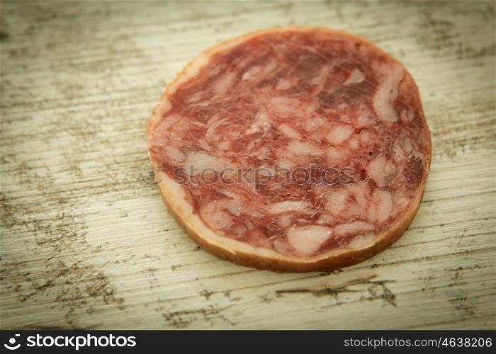 Slice white sausage on a wooden background
