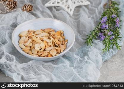 Sliced almonds on a ceramic bowl on christmas table