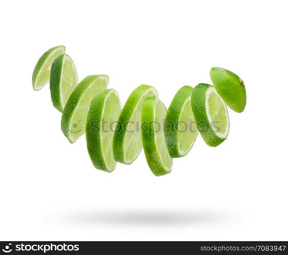 sliced and falling fresh lime isolated on white background