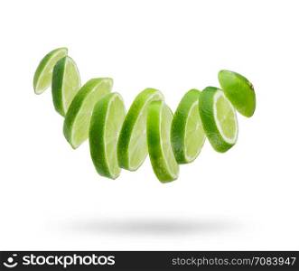 sliced and falling fresh lime isolated on white background