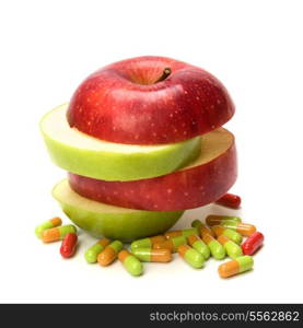 sliced apple and pills isolated on white background