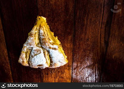 Sliced apple pie with cinnamon on rustic wooden table