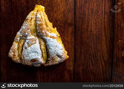 Sliced apple pie with cinnamon on rustic wooden table