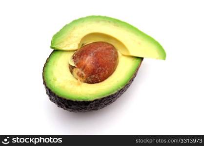 Sliced Avocado. Avocado cut in half exposing the single seed and the various shades of green in the fruit