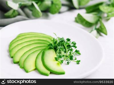 Sliced avocado on white plate