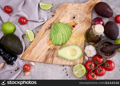 Sliced avocado on wooden cutting board at domestic kitchen.. Sliced avocado on wooden cutting board at domestic kitchen