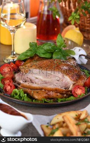 Sliced baked turkey drumstick on a vegetable tray at the Thanksgiving dinner table