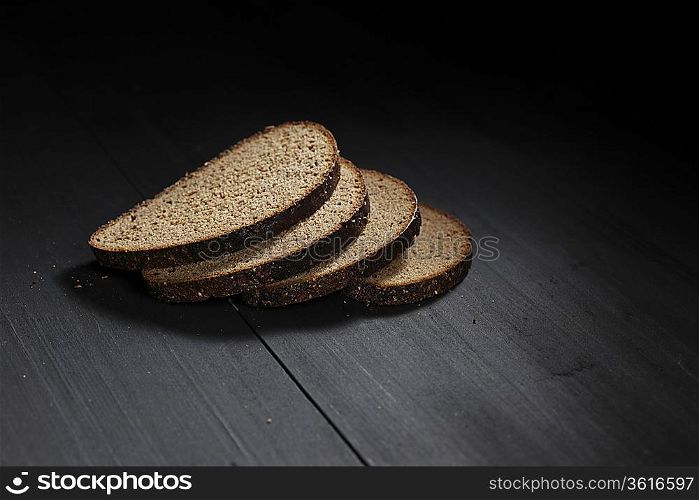 Sliced black bread on wooden table