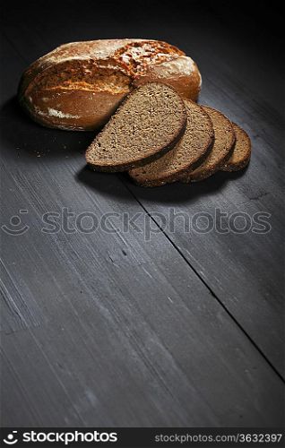 Sliced black bread on wooden table