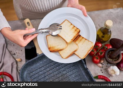 Sliced bread fried on grill frying pan at domestic kitchen.. Sliced bread fried on grill frying pan at domestic kitchen