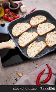 Sliced bread fried on grill frying pan at domestic kitchen.. Sliced bread fried on grill frying pan at domestic kitchen