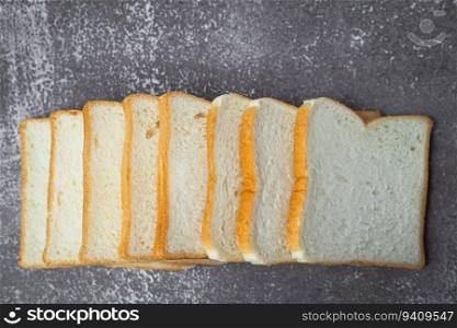 Sliced bread on dark grunge background for bakery, food and eating concept