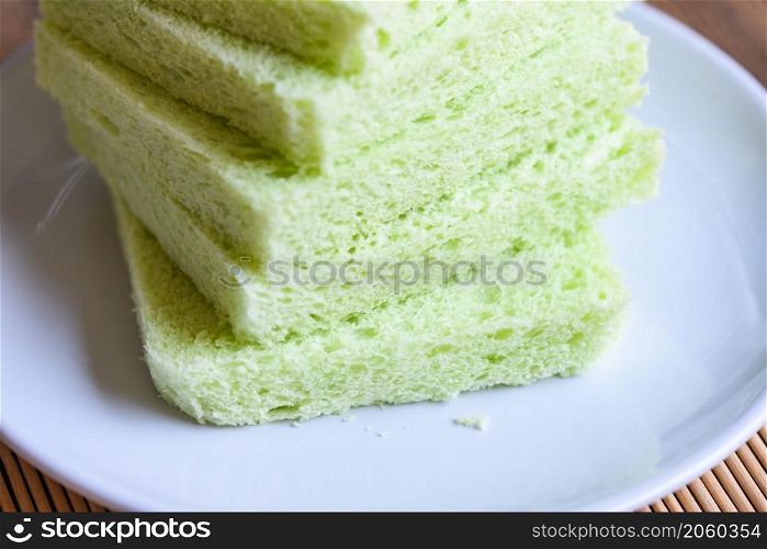 Sliced bread on white plate, Green pandan bread sandwich
