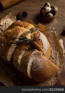 Sliced bread with knife on wood table. Homemade bread at wooden tabletop as baking concept