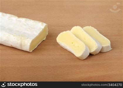 sliced ??brie cheese on a wooden background