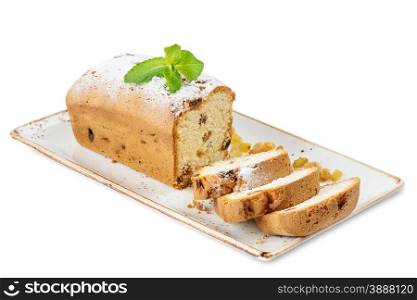 Sliced cake with raisins on a porcelain plate, isolated on a white background