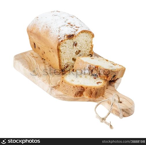 Sliced cake with raisins on a wooden cutting board, isolated on a white background