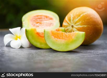 Sliced cantaloupe thai tropical fruit asian and flower on nature background / Cantaloupe Melon Muskmelon Cucurbitaceae