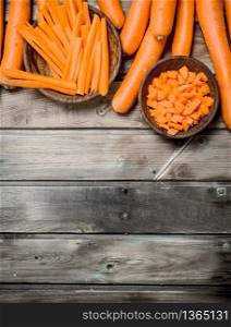 Sliced carrot on bowl. On wooden background. Sliced carrot on bowl.