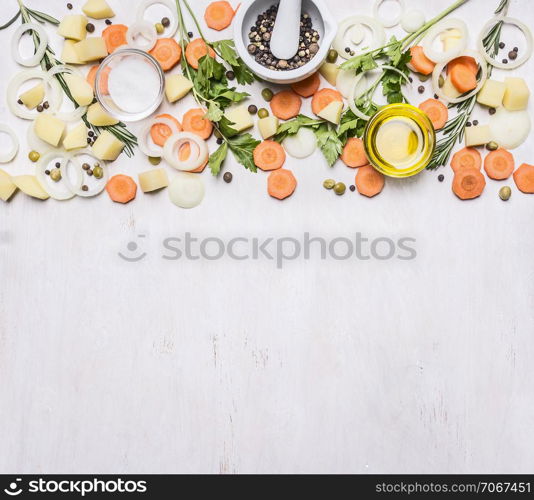 sliced carrots, herbs, onions, butter, seasoning, sliced potatoes, Mortar Grinder pepper border, place for text on wooden rustic background top view vegetarian concept