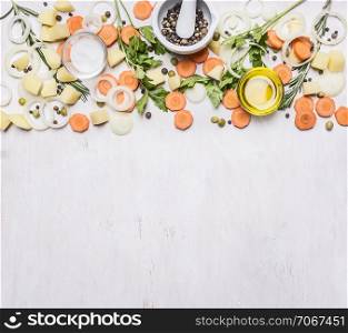 sliced carrots, herbs, onions, butter, seasoning, sliced potatoes, Mortar Grinder pepper border, place for text on wooden rustic background top view vegetarian concept