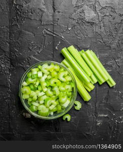 Sliced celery in a bowl. On rustic background. Sliced celery in a bowl.