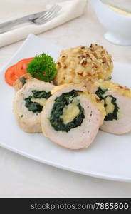 Sliced ??chicken roll stuffed with spinach and mozzarella and cheese with walnuts