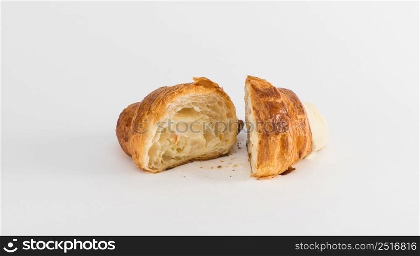 sliced croissant with cream filling on a white background. french croissant on white