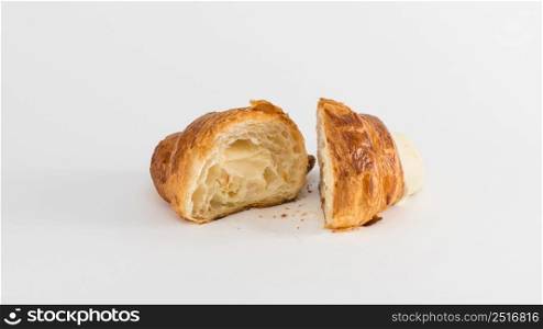 sliced croissant with cream filling on a white background. french croissant on white