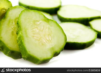 Sliced cucumber closeup isolated on white