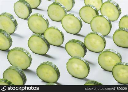 Sliced cucumber on light grey background