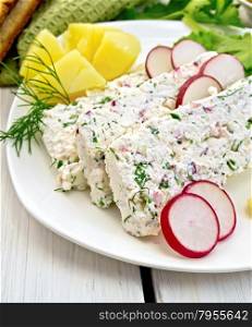 Sliced curd terrine with dill and radishes, green onions, boiled potatoes in a dish, bread, napkin, parsley, lettuce on a light wooden planks