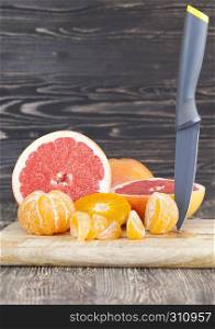 sliced delicious fragrant sour grapefruit and orange tangerines. sliced fragrant and tangerines