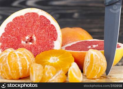 sliced delicious fragrant sour grapefruit and orange tangerines. sliced fragrant and tangerines