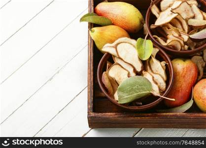 Sliced dried pear pieces.Dried pear or pear chips.Dried fruits. Homemade slices of dried pears