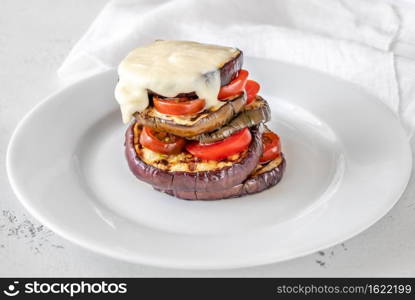 Sliced eggplant with cherry tomatoes and melted mozzarella